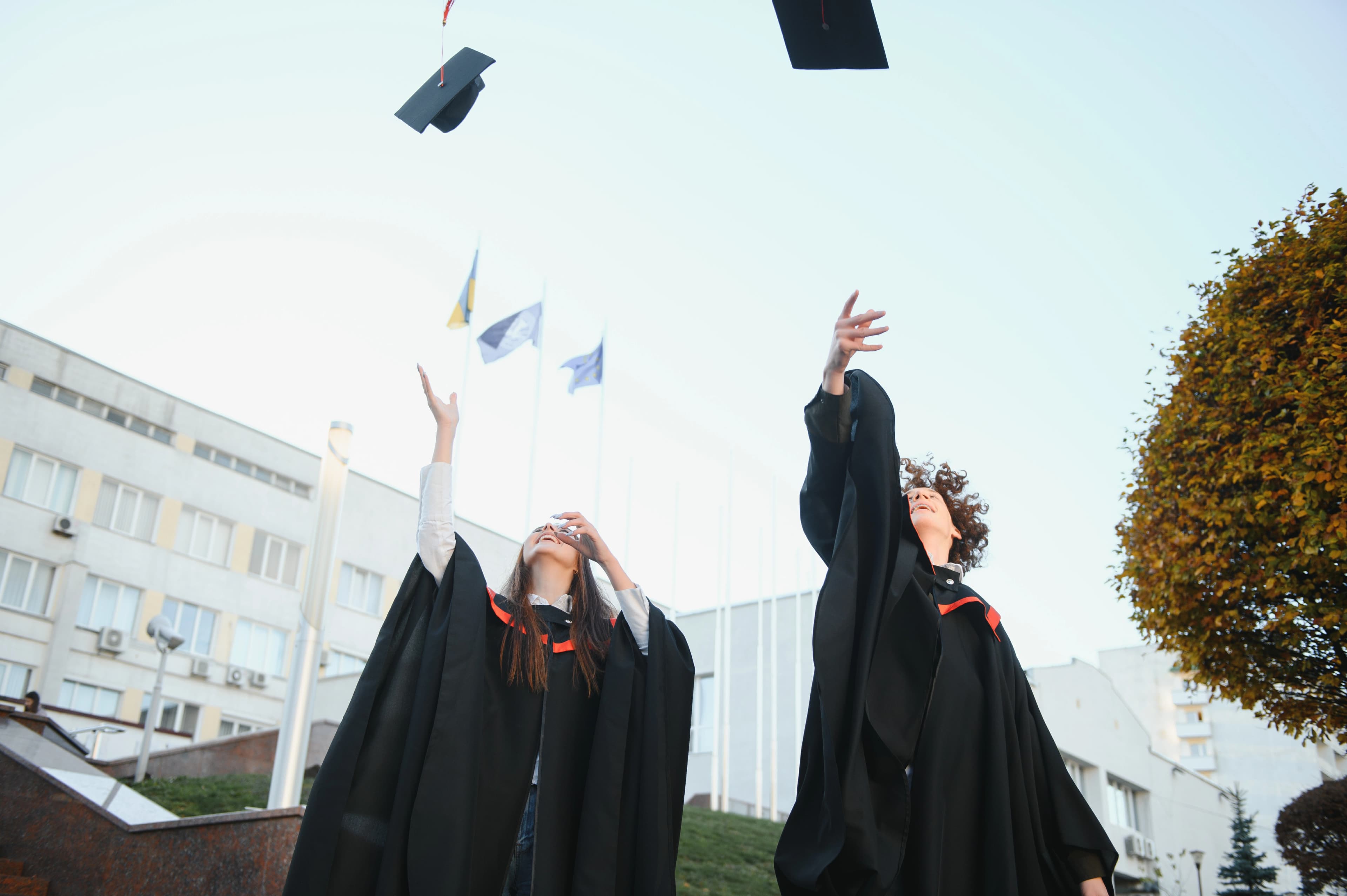 Two graduates celebrating